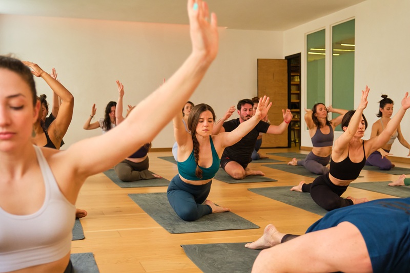 a-large-group-of-people-are-practicing-yoga-in-a-r-ALB2D92.jpg